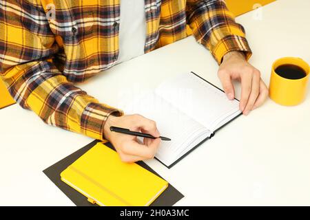 Workplace concept with young man working on table. Stock Photo