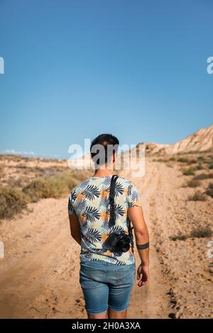Young man with a camera in Bardenas Reales desert, Navarra, Basque Country. Stock Photo