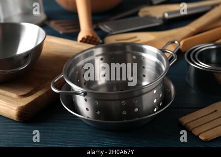 Different kitchen utensil on blue wooden background. Stock Photo