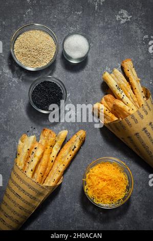 Salted Cheese Straws and Sesame Seeds In A Paper Cone Stock Photo