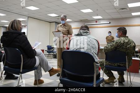 Lt. Cmdr. Karen Downer, assigned to U.S. Naval Hospital (USNH) Naples, gives medical staff a brief on the Moderna coronavirus (COVID-19) vaccine before they are inoculated onboard Naval Support Activity (NSA) Naples, Jan. 8, 2021. USNH Naples, the largest naval hospital in Europe, serves a diverse population of over 9,800 beneficiaries. Over 500 staff members at the main hospital, branch health clinic, and Navy Liaison Detachment in Landstuhl, Germany work tirelessly to keep warfighters in the fight and provide care for their families. Stock Photo