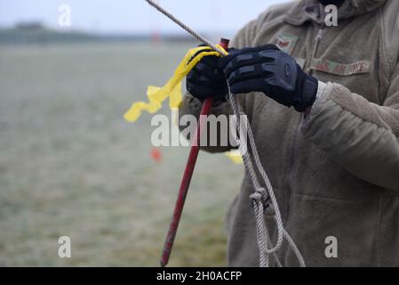 U.S. Air Force Staff Sgt. Andre Reyes, assigned to the 48th Equipment Maintenance Squadron, constructs a forward operating station at Royal Air Force Lakenheath, England, Jan. 8, 2021. Airmen established the FOS during Agile Combat Employment training that enables U.S. Air Forces in Europe to operate from locations with varying levels of capacity and support, ensuring Airmen and aircrews are postured to deliver lethal combat power across the spectrum of military operations. Stock Photo