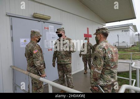 MIHAIL KOGALNICEANU, Romania –   Col. Jeffrey A. Wade, Director of Health Services, Michail Kogaliniceanu, Romania and Novo Solo Training Area, Bulgaria discusses the capabilities of the Troop Medical Clinic with Maj. Gen. Christopher O. Mohan, Commanding General, 21st Theater Sustainment Command, during his visit here Jan 12. One of Maj. Gen. Mohan's biggest focuses during the trip was making sure the base was doing all it could to combat COVID-19 and was prepared for the coming vaccination. “The ability to protect ourselves from COVID and to vaccinate against it will support our overall goal Stock Photo