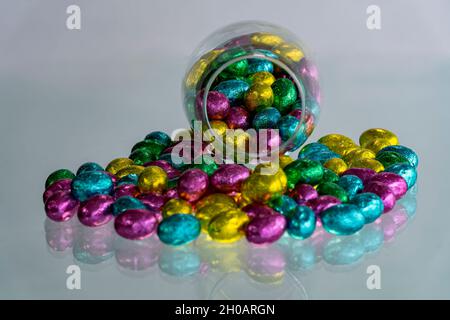 Multi-colored Easter eggs wrapped in foil. Stock Photo