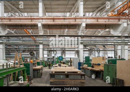 Woodwork factory with stacks of wood and equipment machinery. Professional industrial carpentry manufacturing. Stock Photo