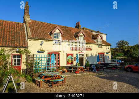 The front of The Hill House Inn pub glowing in the late afternoon sunshine in Happisburgh, Norfolk, England. Stock Photo