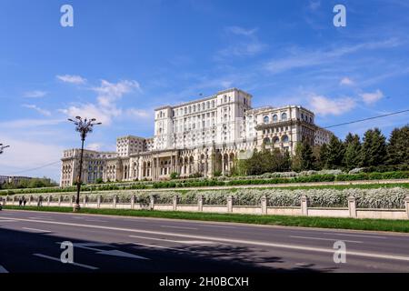 The Palace of the Parliament also known as People's House (Casa Popoprului) in Constitutiei Square (Piata Constitutiei) in Bucharest, Romania, in a su Stock Photo