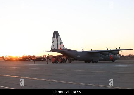 U.S. Air Force Airmen with the California National Guard's 146th Logistics Readiness Squadron and the 146th Air Lift Squadron work together to load gear for Cal Guard Soldiers at Joint Forces Training Base, Los Alamitos, California who are being transported to Washington DC to support the 59th presidential inauguration. Stock Photo