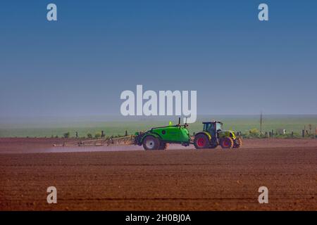 Chemical treatment of crops with very wide spreading behind a tractor, field crops, agricultural territories, Senlis region, Department of Oise, Franc Stock Photo