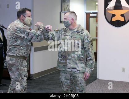 Command Sgt. Maj. Christopher Gunn (right) is greeted by Lt. Col. Kevin Taaffe of the British Army following Gunn’s Relinquishment of Responsibility Ceremony on Jan. 19 at Fort Bliss, Texas. Stock Photo