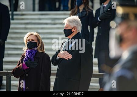 Former President William Clinton and Secretary Hillary Clinton render honors during a Presidential Armed Forces Full Honors Wreath-Laying Ceremony at the Tomb of the Unknown Soldier at Arlington National Cemetery, January 20, 2020. The wreath was laid by President Joseph R. Biden, Jr. and Vice President Kamala Harris after Biden was sworn-in as the 46th president of the United States in a ceremony at the U.S. Capitol earlier that morning. In attendance were First Lady Dr. Jill T. Biden and Second Gentlemen Douglas Emhoff, as well as former Presidents Barack H. Obama and George W. Bush, and for Stock Photo