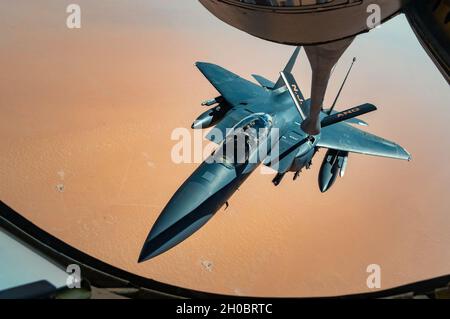 A U.S. Air Force F-15E Strike Eagle receives fuel from a U.S. Air Force KC-135 Stratotanker, assigned to the 28th Expeditionary Aircraft Refueling Squadron, during an in-air refueling mission over Southwest Asia Jan. 20, 2021. The F-15E is a dual-role fighter designed to perform air-to-air and air-to-ground missions. Stock Photo