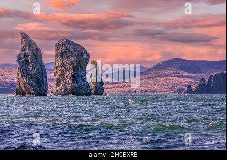 scenery seascape at sunset: view of beautiful islands Three Brothers Rocks in Avacha Bay on Kamchatka Peninsula Stock Photo