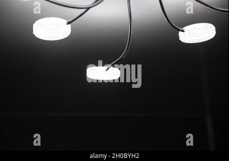 Modern LED chandelier on the ceiling of the house. Lighting with diodes Stock Photo