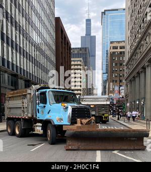 Snowplow blocks off a street in downtown Chicago during the 2021 Bank of America Chicago Marathon. Stock Photo