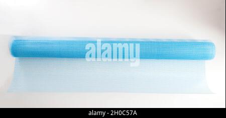 Blue reinforcing construction mesh for wall strengthening on white background, isolate. Stock Photo