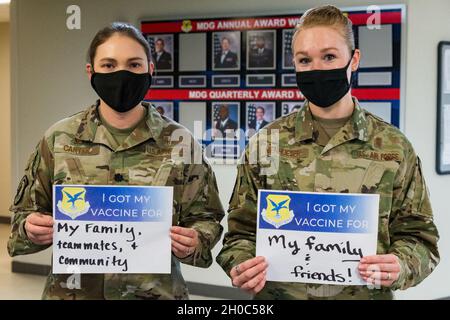 Lt. Col. Kristen Carter, 436th Medical Support Squadron commander, and Master Sgt. Jessica Nienhueser, 436th MDSS superintendent, display their signs stating why they volunteered for the COVID-19 vaccine on Jan. 21, 2021, at Dover Air Force Base, Delaware. Carter and Nienhueser were among the first Team Dover front-line workers who voluntarily received the vaccine in accordance with Department of Defense guidance. The vaccine was granted emergency use authorization by the U.S. Food and Drug Administration for use in prevention of COVID-19. Stock Photo