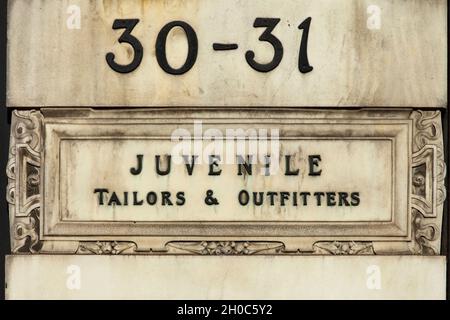 Sign on building in Princes Street, Edinburgh, Scotland for a Juvenile Tailor's shop.