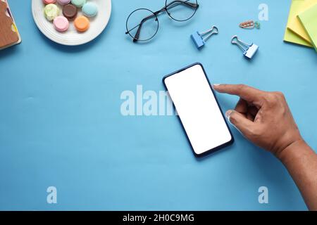 top view of man hand using smart phone on office desk  Stock Photo