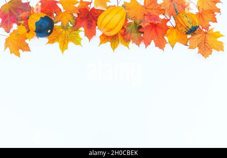 Autumn decor from pumpkins and leaves on a white background. Flat lay autumn composition with copy space. Stock Photo