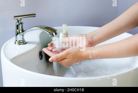 Bucket full of soap suds and hand washing Stock Photo - Alamy