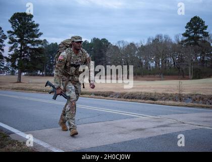 Sgt. 1st Class Marlon Smith passes the Camp Robinson golf course in the opening miles of the ten mile ruck march.    Soldiers from the National Guard Professional Education Center participated in a ten mile ruck march, January 22, 2021.  Some participated for fun and some to test themselves before attending the Army Air Assault School.  1st. Sgt. Carlos Cota, NGPEC headquarters and headquarters company first sergeant, organized the ruck march to ensure Soldiers attending the Army Air Assault School were ready to complete the 12 mile ruck march that concludes the ten day course. Stock Photo