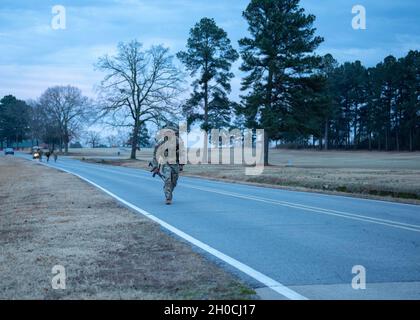 Sgt. 1st Class Marlon Smith passes the Camp Robinson golf course in the opening miles of the ten mile ruck march.    Soldiers from the National Guard Professional Education Center participated in a ten mile ruck march, January 22, 2021.  Some participated for fun and some to test themselves before attending the Army Air Assault School.  1st. Sgt. Carlos Cota, NGPEC headquarters and headquarters company first sergeant, organized the ruck march to ensure Soldiers attending the Army Air Assault School were ready to complete the 12 mile ruck march that concludes the ten day course. Stock Photo