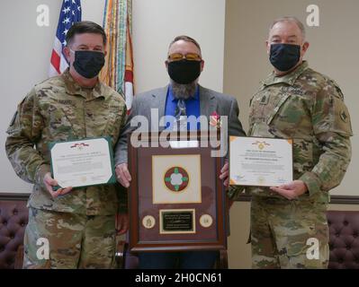 Sgt. Maj. David Thompson, retired, stands with Col. Jonathan 'Scott' Hubbard, commander of the 184th Sustainment Command, and Command Sgt. Maj. Jason Little, 184th's senior enlisted advisor, following his retirement ceremony held at Monticello on Jan. 24, 2021. Stock Photo