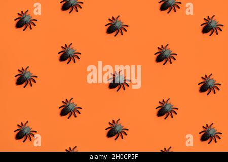 Creepy Halloween pattern with black spiders on orange background ...