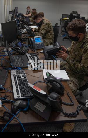 U.S. Air Force Airman Thatcher LaPrise, 338th Training Squadron student, practices connecting a phone to a network in Bryan Hall at Keesler Air Force Base, Mississippi, on Jan. 26, 2021. The 338th TRS has been working towards a modular curriculum, which enables students to receive the training tailored to their future assignment, for approximately five years. Stock Photo