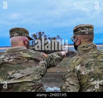 Brig. Gen. Paul Owen, commanding general of the U.S. Army Corps of Engineers South Pacific Division, points out features of Folsom Dam and Lake to Maj. Gen. William Graham, USACE deputy commanding general for civil and emergency operations, at Folsom Dam Dike 8 Jan. 27, 2021. Maj. Gen. Graham came to visit several district projects including Dike 8, Lower Cache Creek and the Sacramento Weir as part of a larger visit to the South Pacific Division. At each site, the general heard from project leaders within USACE and any other interagency collaborators and received an overview of work done or pl Stock Photo