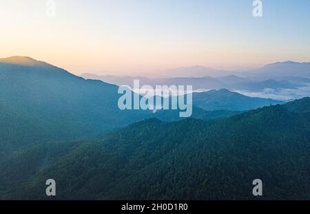 (211012) -- HAIKOU, Oct. 12, 2021 (Xinhua) -- Aerial photo taken on Sept. 30, 2021 shows the view of the Hainan Tropical Rainforest National Park in south China's Hainan Province.  The Hainan Tropical Rainforest National Park in south China's Hainan Province boasts one of the most concentrated, best preserved and largest contiguous tropical rainforests in China.   The park covers nine cities and counties, with a total area of 4,400 square km, or about one-seventh of Hainan Island's land area. It is an important part of the world's tropical rainforest and a key area for biodiversity conservatio Stock Photo