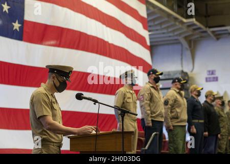 PHILIPPINE SEA (Jan. 29, 2021) Chief Mass Communication Specialist Mark R. Alvarez, assigned to USS America (LHA 6), the Navy’s only forward-deployed amphibious assault ship, reads the Chief Petty Officers' Creed during a chief petty officer promotion ceremony in the ship’s hangar bay. The Navy is unique among the services in recognizing and celebrating promotion to E-7 as a major milestone in a Sailor’s career. America, flagship of the America Expeditionary Strike Group, along with the 31st Marine Expeditionary Unit, is operating in the U.S. 7th Fleet area of responsibility to enhance interop Stock Photo