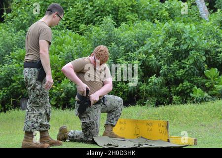 U.S. Navy Master-at-Arms Apprentice takes notes while on a phone call ...