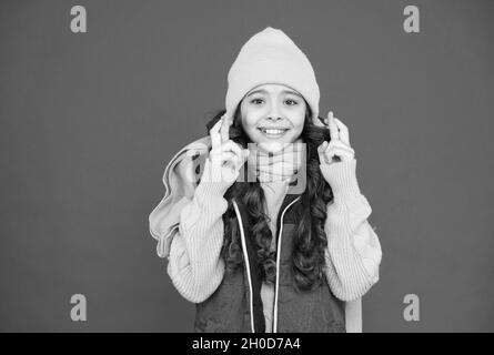 an amazing day. make a wish. cheerful girl crossed fingers. let the miracle happen. xmas holiday mood. happy childhood. christmas sale and discounts Stock Photo