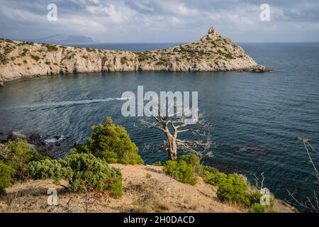 Panorama of cape Kapchik near coastline of Black Sea. Shape of mountain reminds sleeping animal, face turned to left, rock on top is like ear, small i Stock Photo