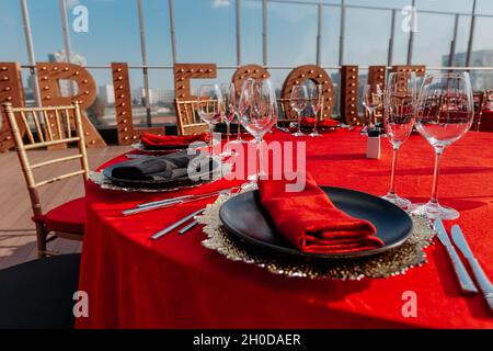 Guests table setting for banquet in black, red and gold style