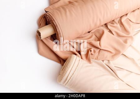 Rolls of pastel color fabric isolated on white, Synthetic and natural fabrics Stock Photo