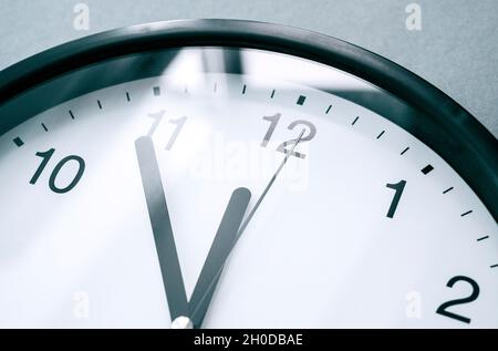 Close-up of clock face or dial with elegance black arrows and numbers. 12 o'clock, business concept picture Stock Photo