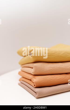 Stacks colorful cotton fabric, clothes. Copyspace Stock Photo