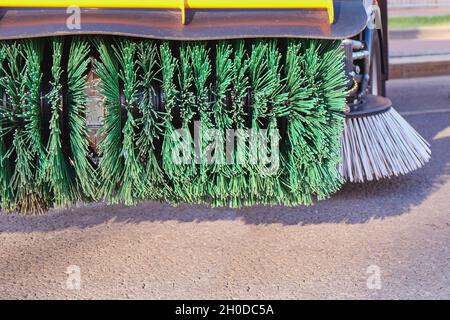 Rotating new brush of street sweeper cleaning machine.Big round broom of street sweeper with wide sweeping path Stock Photo