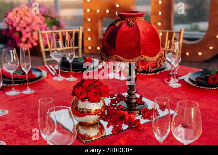 Guests table setting for banquet in black, red and gold style