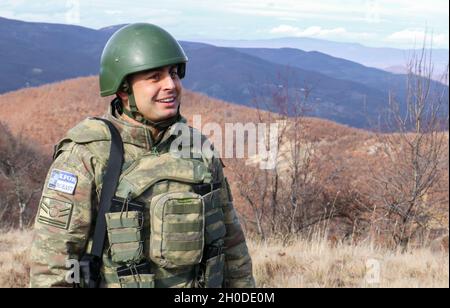 A Turkish Armed Forces soldier assigned to Regional Command-East, Kosovo Force, smiles during a patrol along the administrative boundary line in Kosovo on Feb. 1, 2021. His platoon took a flight from Camp Bondsteel to be dropped off at a point on the ABL. KFOR regularly patrols the ABL to maintain the safety and security of people in the region. Stock Photo