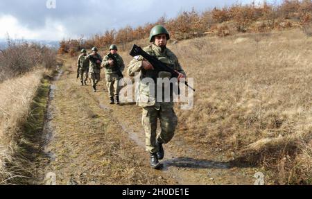 Turkish Armed Forces soldiers assigned to Regional Command-East, Kosovo Force, conduct a foot patrol along the administrative boundary line in Kosovo on Feb. 1, 2021. The platoon took a flight from Camp Bondsteel to be dropped off at a point on the ABL. KFOR regularly patrols the ABL to maintain the safety and security of people in the region. Stock Photo