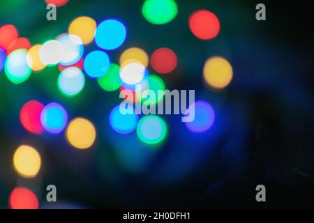 Colorful Bokeh Lights in Blue, Green, Red, and Yellow on a Dark Background Stock Photo