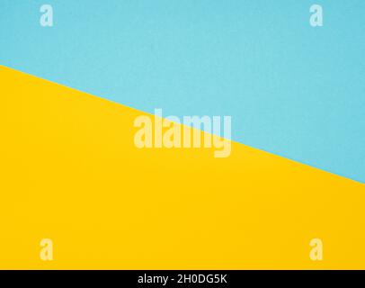 Bright yellow and blue cardboard, colored blank sheets as texture or background, space for text, top view Stock Photo