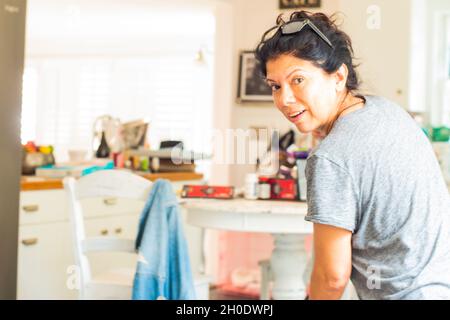 Latin woman cleaning The kitchen Stock Photo