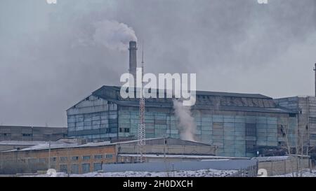 This smoke coming from the chimney in a factory. Harmful emissions into the atmosphere, from the pipe. Serious damage the environment. Stock Photo