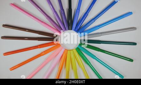 Many colored pencils are arranged around the edges of the image as a frame. In the center is an empty background with space for text. Stock Photo