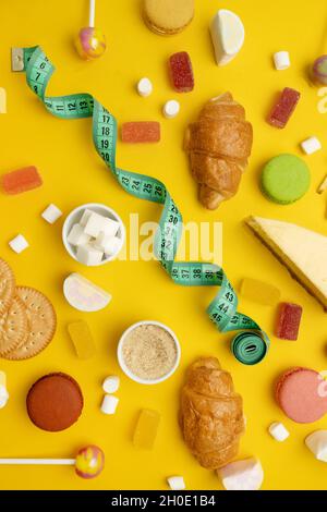 Colorful candies on a bright yellow background. Stock Photo